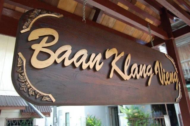 Carved wooden Baan Klang Vieng sign